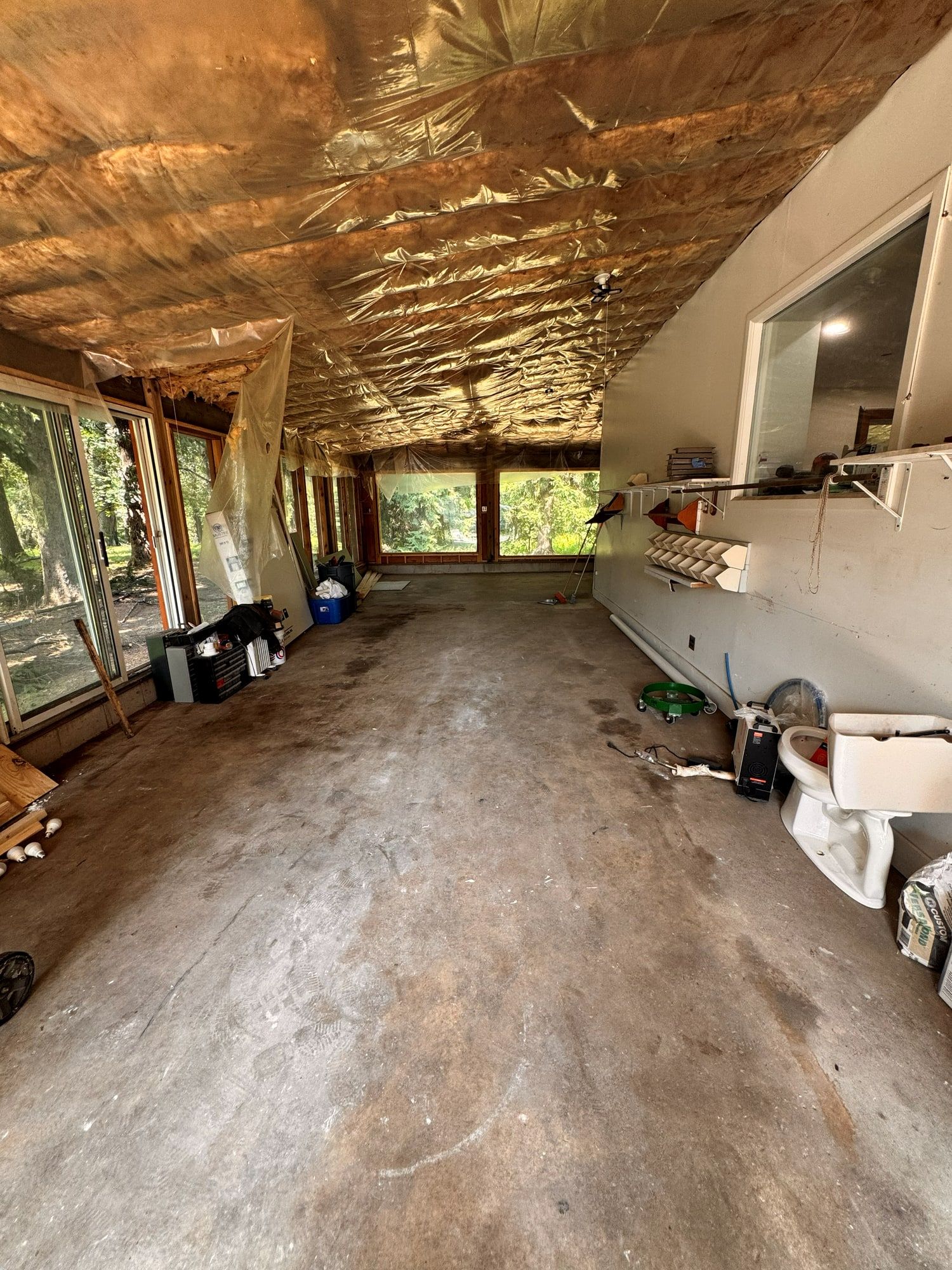 Sunroom swept clean down to the concrete after renovation debris removal