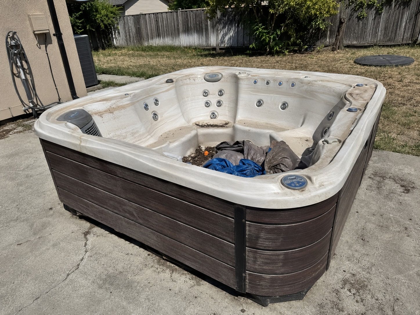 Weathered spa shell with worn jets up close